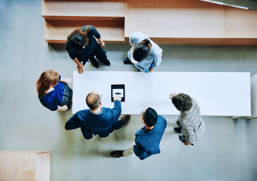 Six people gathered around a tablet