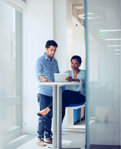 a couple of coworkers looking at a laptop