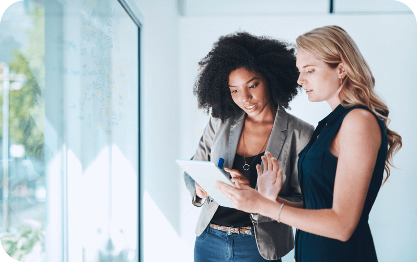 Two women chatting in an office setting