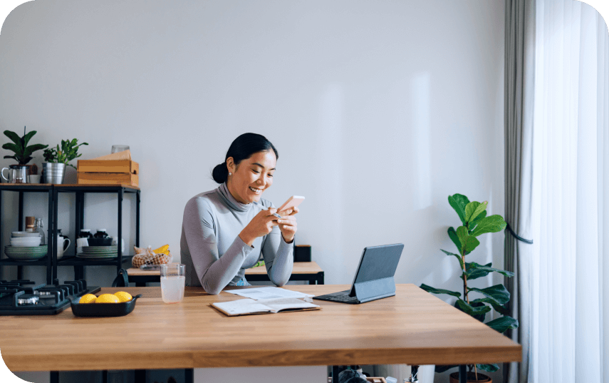 Woman smiling while viewing her phone